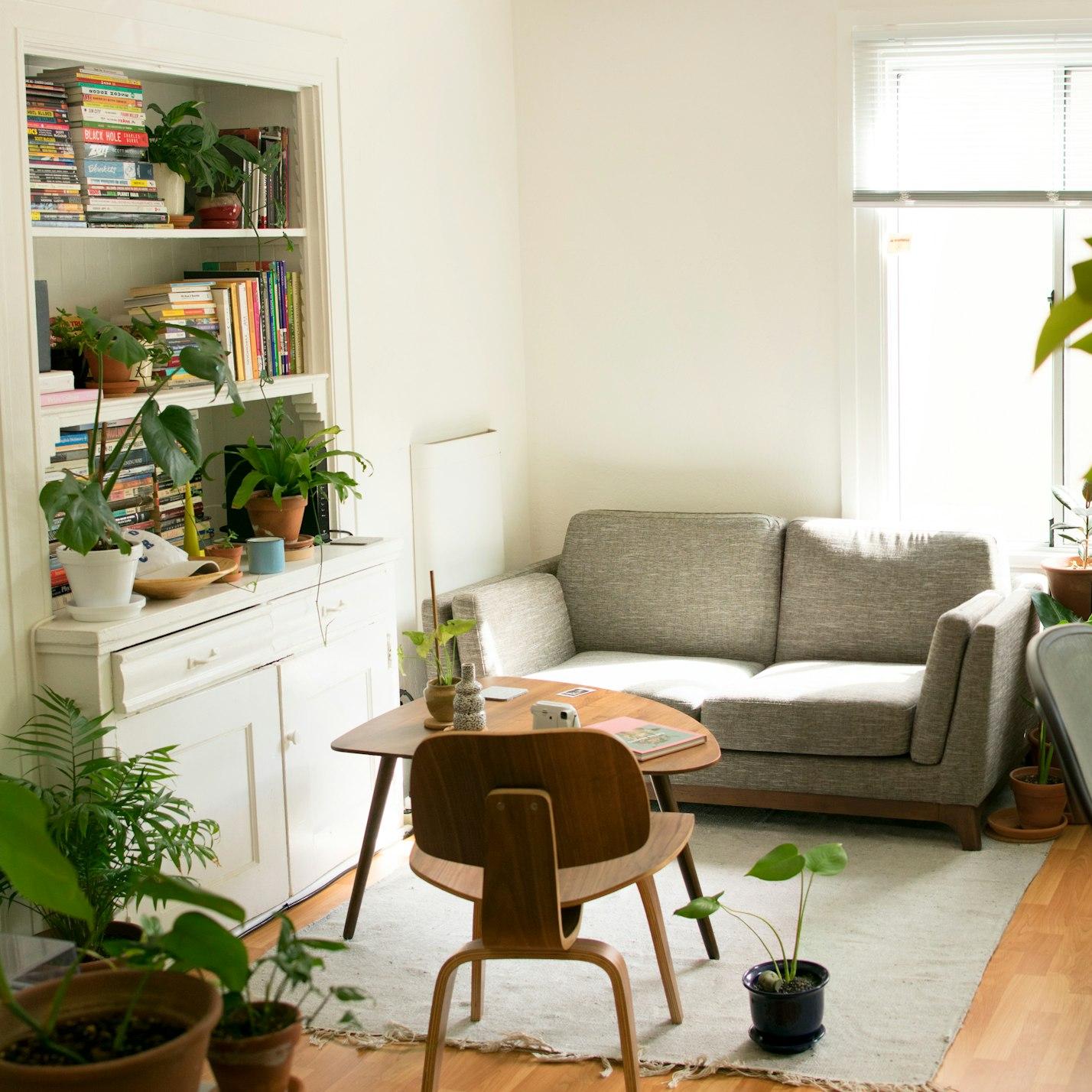 gray fabric loveseat near brown wooden table